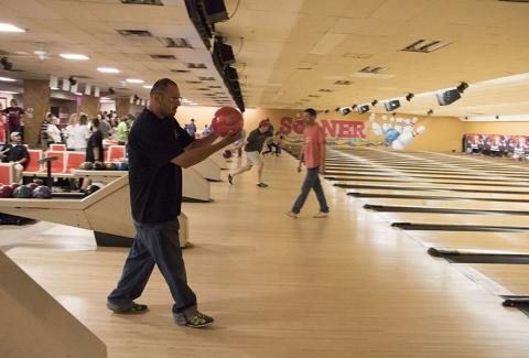 Man bowling at event