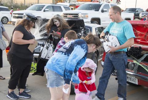 Volunteers pass out candy