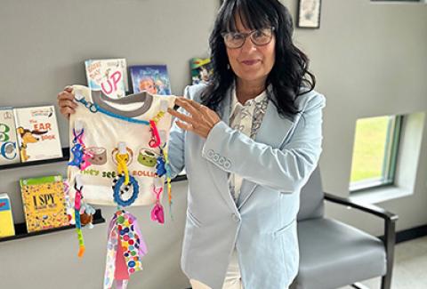 Employee displays sensory bib
