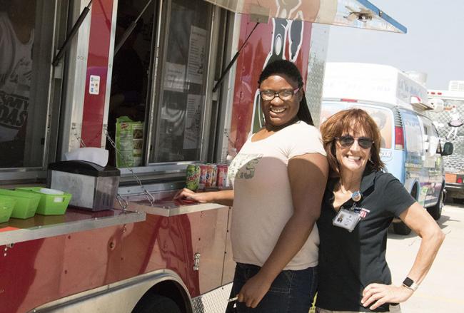 Visitors purchase food from food truck