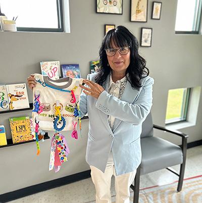 Employee displays sensory bib
